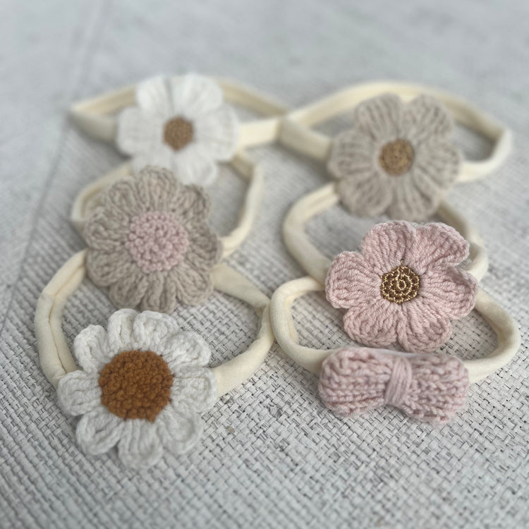 Set of three knitted headbands with floral designs