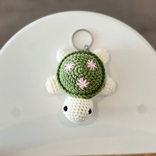 Green crochet turtle with pink flower keychain