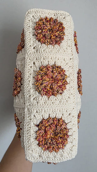Crocheted bag with brown flower patterns