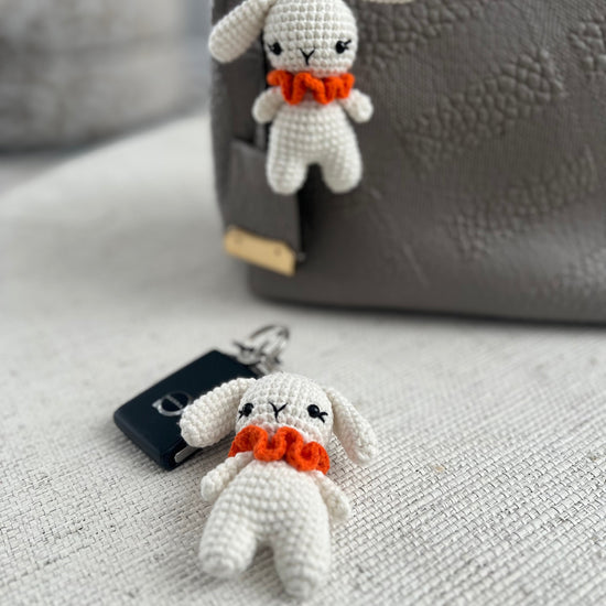 white crocheted bunny keychains with orange scarves 