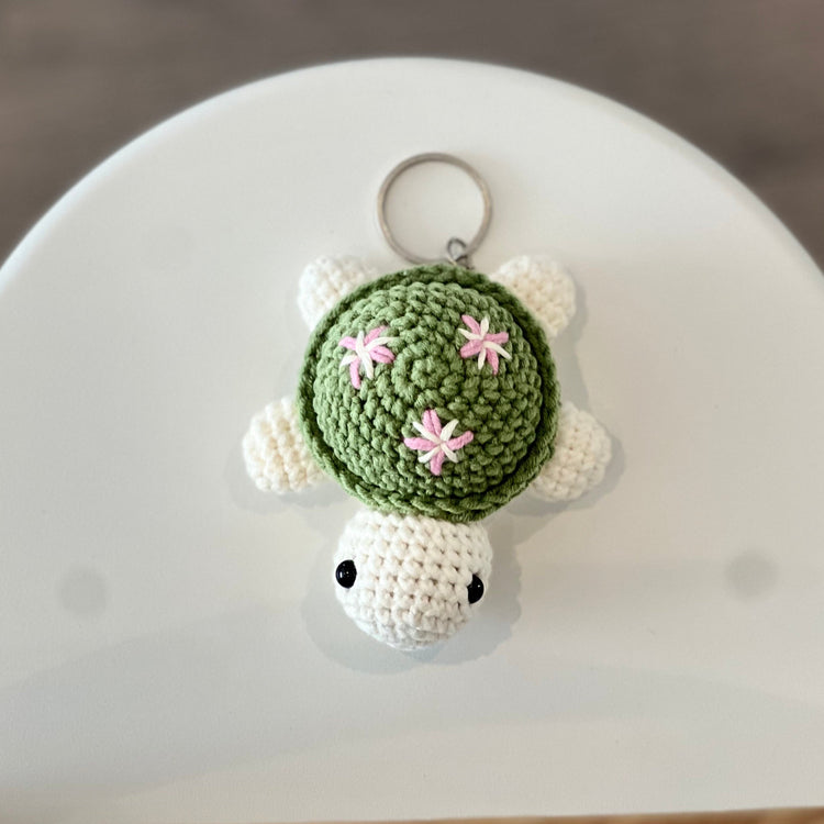 Green crochet turtle with pink flower keychain